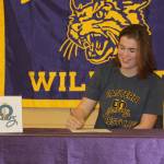 Meredith Bain signs a letter of intend Thursday to wrestle for Eastern Oregon University. (Photo by Jim Waller/Whidbey News-Times)