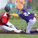 Oak Harbor&rsquo;s Jordan Ronning tags Caleb Meyer as Meyer tries to get back to third base. (Photo by John Fisken)
