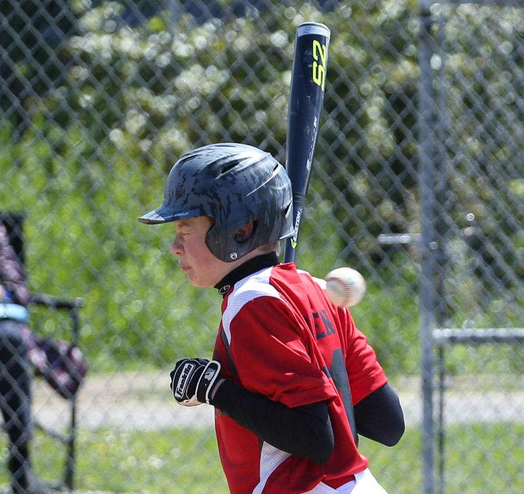 Daniel Olson gets plunked by an errant pitch. (Photo by John Fisken)