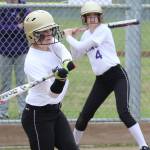 Shea Davis attacks a pitch while Megan Flood (4) waits on deck. (Photo by John Fisken)