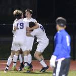 Oak Harbor celebrates it winning goal Monday. JJ Mitchell, center, booted the golden goal in overtime and is joined by Kegan Snell (19), Kurtis Zylstra and Julian Hinkle (8). (Photo by John Fisken)