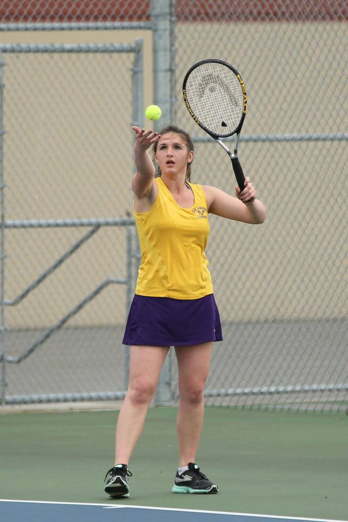 Maddie McKenzie serves for Oak Harbor in the Getchell match Tuesday. (Photo by John Fisken)