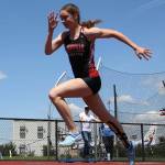 Freshman Maya Toomey-Stout, shown here running the 200, qualified for the state meet in four events. (Photo by John Fisken)
