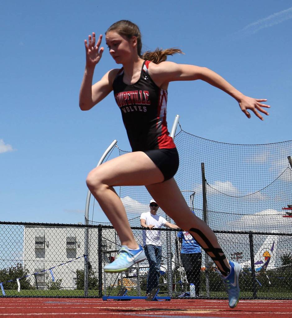 Freshman Maya Toomey-Stout, shown here running the 200, qualified for the state meet in four events. (Photo by John Fisken)