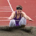 Jordan Bell hits the landing pit in the triple jump. (Photo by John Fisken)