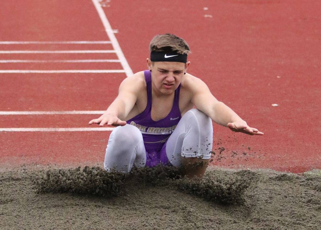 Jordan Bell hits the landing pit in the triple jump. (Photo by John Fisken)
