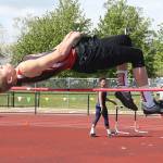 Ariah Belpler leaps his way to first place in the district high jump. (Photo by John Fisken)