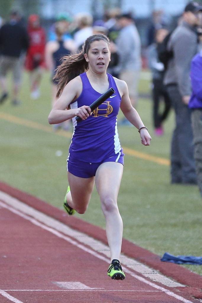 Jenna Cooley crosses the finish line as the Wildcats take fourth in the 4x400 relay. Cooley placed in three other events at the North Championships. (Photo by John Fisken)