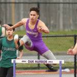 Aaron Fletcher races to second place in the 300 hurdles Tuesday. He also won the JV 110 high hurdles. (Photo by John Fisken)