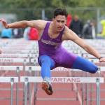 Aaron Fletcher skims over a hurdle in the 110 highs. (Photo by John Fisken)
