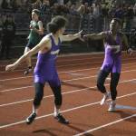 TJ Passmore hands offs to Miguel Guzman in Oak Harbor&rsquo;s win in the 4x400 relay. (Photo by John Fisken)
