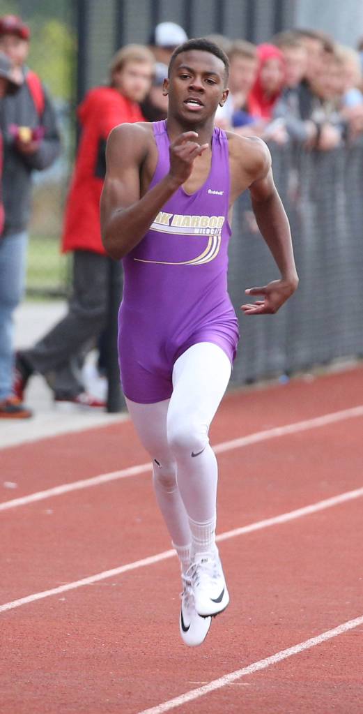 TJ Passmore sprints to the finish line in a 200-meter preliminary heat Wednesday. (Photo by John Fisken)