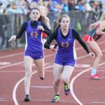 Jennifer Turnek hands the baton to Taylor Kesler in the 4x400 relay Friday. Oak Harbor went on to finish fourth. (Photo by John Fisken)
