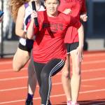 Mariko Johnston takes the baton in the eighth-grade girls winning 4x200 relay. (Photo by John Fisken)