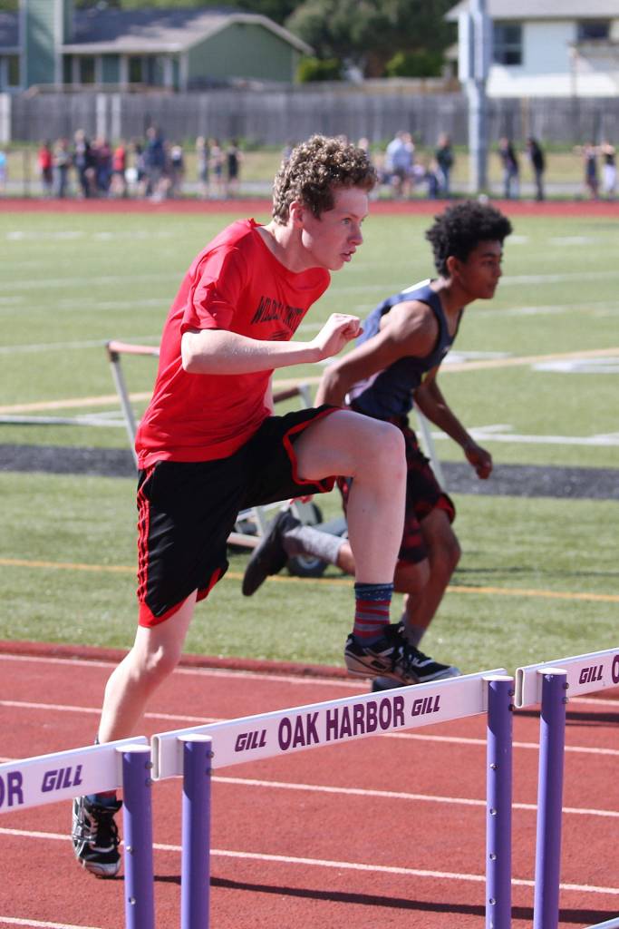 Zachary Moore races to first place in the 110 hurldes. (Photo by John Fisken)