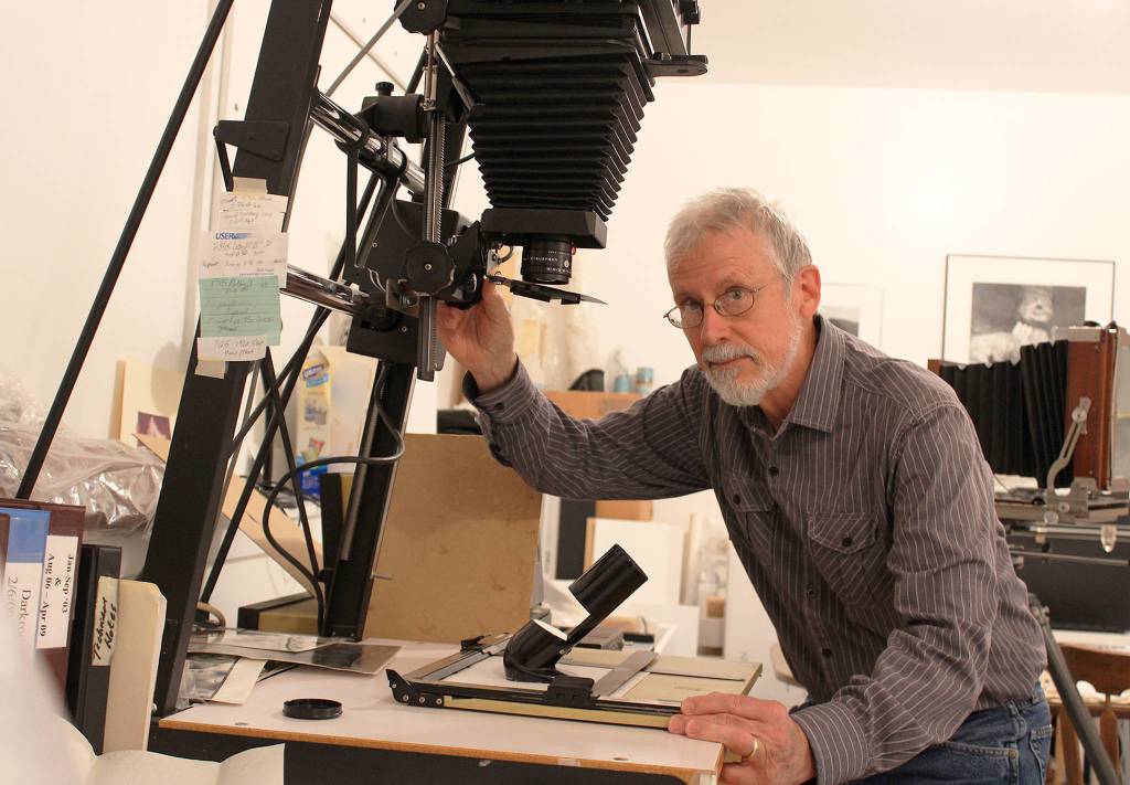 John Olsen specializes in black and white photography using classic large-format cameras. He develops and prints film in his dark room at his Coupeville home.                                Photo by Patricia Guthrie/Whidbey News-Times