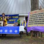 Mayor Molly Hughes explains the history behind the old sign at the town park kitchen shelter and explains a new sign will be installed in its place. Photo by Megan Hansen/Whidbey News-Times