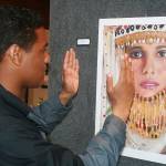 Oak Harbor art student Julian Mata describes all the strengths in Marie Kelley&rsquo;s oil painting, &ldquo;Preservation,&rdquo; at Christian Reform Church&rsquo;s annual high school art show last month. Photo by Daniel Warn/Whidbey News-Times