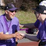 Ron Ernst, left, shakes the hand of a fellow cancer survivor during the Relay for Life of Whidbey Island event Friday, June 2, 2017, at North Whidbey Middle School in Oak Harbor. Photo by Ron Newberry/Whidbey News-Times