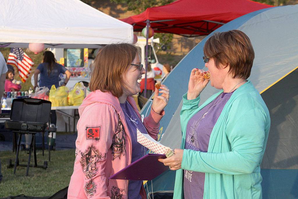 Dawnelle Conlisk shares a snack and some laughs with her daughter Mary at the The Relay for Life of Whidbey Island event Friday, June 2, 2017, at North Whidbey Middle School in Oak Harbor. Conlisk has been dealing with cancer for 22 years. Photo by Ron Newberry/Whidbey News-Times