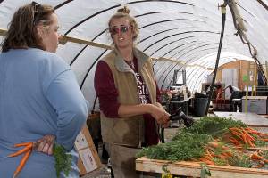 Photos by Ron Newberry/Whidbey News-Times                                Coupeville farmer Georgie Smith, left, speaks with Willowood harvest manager Alanah Lawrason last week while she rinsed off Mokum carrots in the farm&rsquo;s newly constructed packing shed. Nearly three months after a fire destroyed a historic barn on her property, Smith has watched a steady recovery and is overwhelmed by generosity from the community.