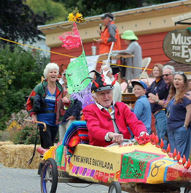 Peter Lawlor competes in Langley&rsquo;s 2016 Soup Box Derby that&rsquo;s a race to raise money for local food banks. He said he plans to enter his jalopy, &ldquo;The Whole Enchilada&rdquo; again this August, maybe with a different sauce. Running close behind him is his daughter, Gretchen Lawlor. Photo by Kyle Jensen/South Whidbey Record