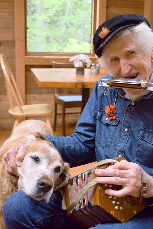 Peter Lawlor and his dog, Claude, are Saturday morning regulars at Cafe in the Woods near Langley. For customers, he plays and sings songs of the sea from his worldwide travels. The native New Zealander, 95, has lived in Clinton the past dozen years. &ldquo;I&rsquo;m proud of my age,&rdquo; he says. &ldquo;I think I&rsquo;ve had a good go.&rdquo;