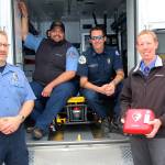 Coupeville teacher and South Whidbey firefighter Jon Gabelein, far right, meets with first responders whom he says represent collaboration among agencies on the island. Gabelein was recently involved in helping to save a woman using an AED, one of which he is holding. From left are Gregory Behan, an EMT with WhidbeyHealth, Scott Jackson, a paramedic, and Capt. Jerry Helm with Coupeville Fire & Rescue.