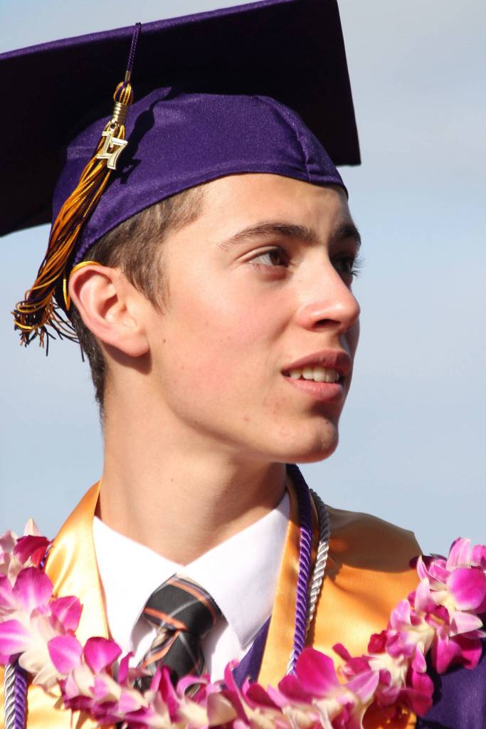 Graduate Kelly Holt makes his way to the 50-yard line of Wildcat Memorial Stadium, where the 2017 Oak Harbor High School commencement ceremony took place Monday. Photo by Daniel Warn/Whidbey News-Times