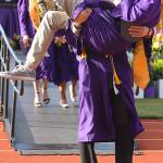 Student speaker Seth Gluth carries fellow graduate Joshua Coe down the ramp, both with diplomas in hand. Gluth of one of five student speakers of the Oak Harbor High School commencement ceremony Monday. Photo by Daniel Warn/Whidbey News-Times