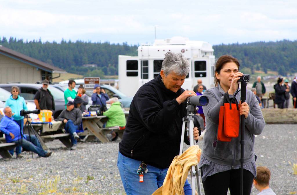 A large crowd, some with large lenses, took in the sights of tall ships during the Parade of Sail as the flotilla passed through Admiralty Inlet Tuesday on the west side of Whidbey Island. Photo by Ron Newberry/Whidbey News-Times