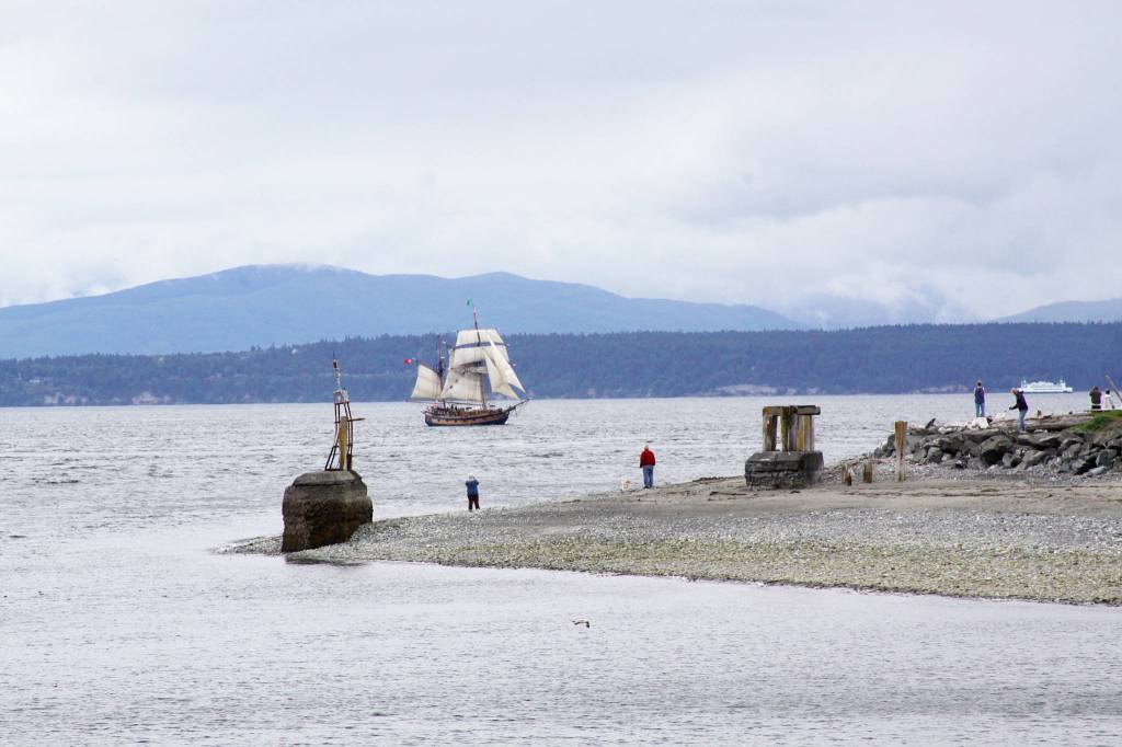 Tall ships during the Parade of Sail pass through Admiralty Inlet Tuesday drawing a large crowd from the beaches on the west side of Whidbey Island. Photo by Ron Newberry/Whidbey News-Times
