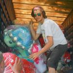 Zach Nix, from Colorado, offloads a truck full of carnival prizes Thursday at Windjammer Park in preparation for the Fourth of July Carnival. Photo by Daniel Warn/Whidbey News-Times