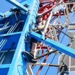 Dan DeRoest, a ride operator from Coosbay, Ore., performs maintenance on the Zipper Thursday at Windjammer Park in preparation for the Fourth of July Carnival. Photo by Daniel Warn/Whidbey News-Times
