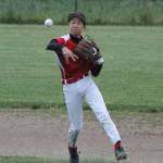 George Dailey flips the ball to first in an attempt to throw out an Anacortes batter. (Photo by Jim Waller/Whidbey News-Times)