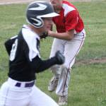 After fielding a tap back to the mound, Coupeville pitcher Gavin Knoblich, right, prepares to throw to first.(Photo by Jim Waller/Whidbey News-Times)