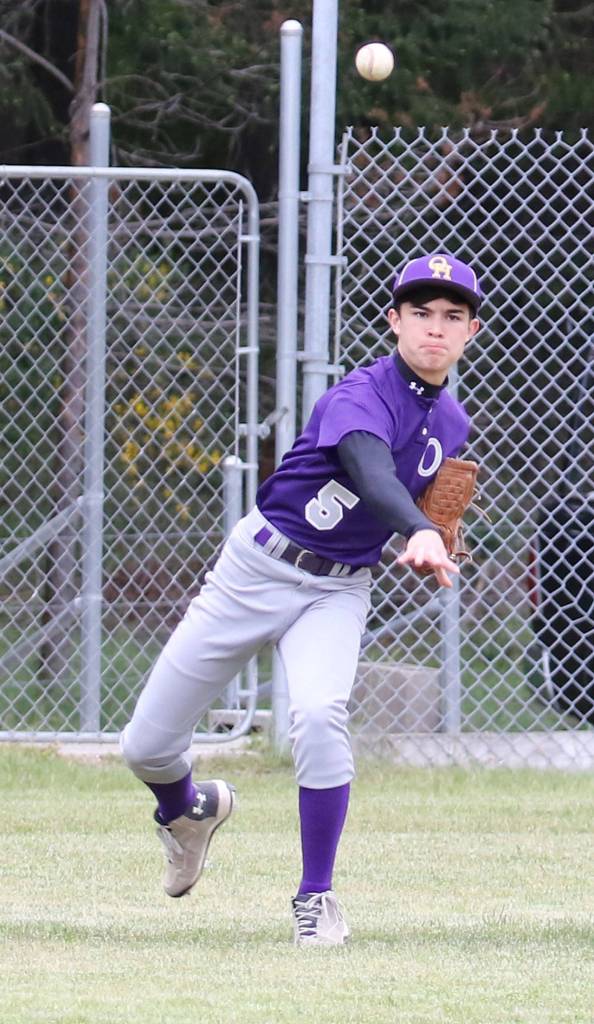 After fielding a ground ball, pitcher Kyto Morrow throws to first base for a force out. (Photo by John Fisken)