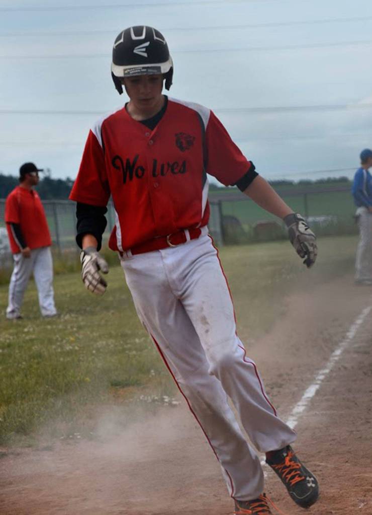 Cody Roberts scores for Coupeville on Chelsea Prescott&rsquo;s hit. (Photo by Karen Carlson)