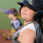 Central Whidbey&rsquo;s Brionna Blouin listens to coach Fred Farris after reaching first base. (Photo by Jim Waller/Whidbey News-Times)