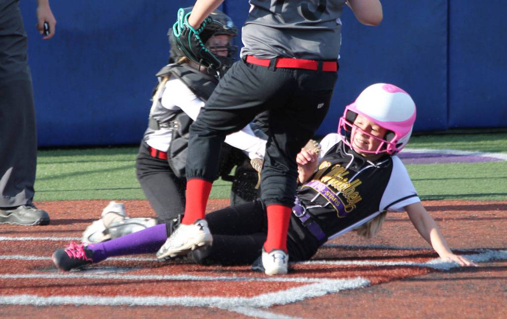 Central Whidbey catcher Teagen Calkins tags out Caidence Meadors on a close play at the plate. (Photo by Jim Waller/Whidbey News-Times)