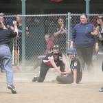 Umpire Rita Cline calls out an Orcas Island runner at third base as Audrianna Shaw applies the tag and Coral Caveness looks on. (Photo by John Fisken)