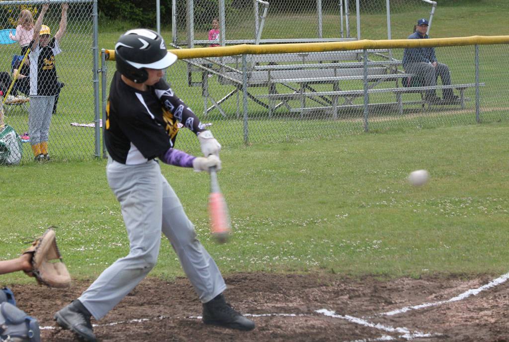 Conner Lacy attacks a pitch in Saturday&rsquo;s first game. (Photo by Jim Waller/Whidbey News-Times)