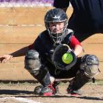 Central Whidbey catcher McKaela Meffert hauls in a pitch in the opening game. (Photo by John Fisken)