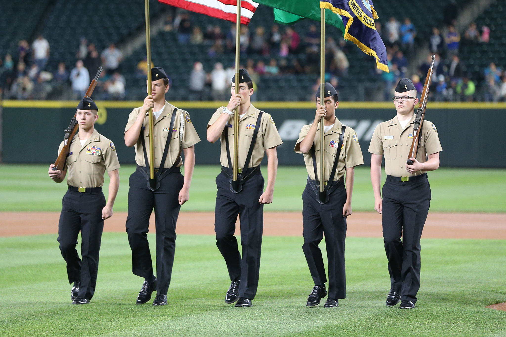 Dylan Sanchez, left, Andrew Lof, Mac Nuanez, Jhaylan Munger and Luke Davis present the colors at last Wednesday&rsquo;s game. (Photo by John Fisken)
