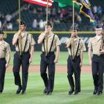 Dylan Sanchez, left, Andrew Lof, Mac Nuanez, Jhaylan Munger and Luke Davis present the colors at last Wednesday&rsquo;s game. (Photo by John Fisken)