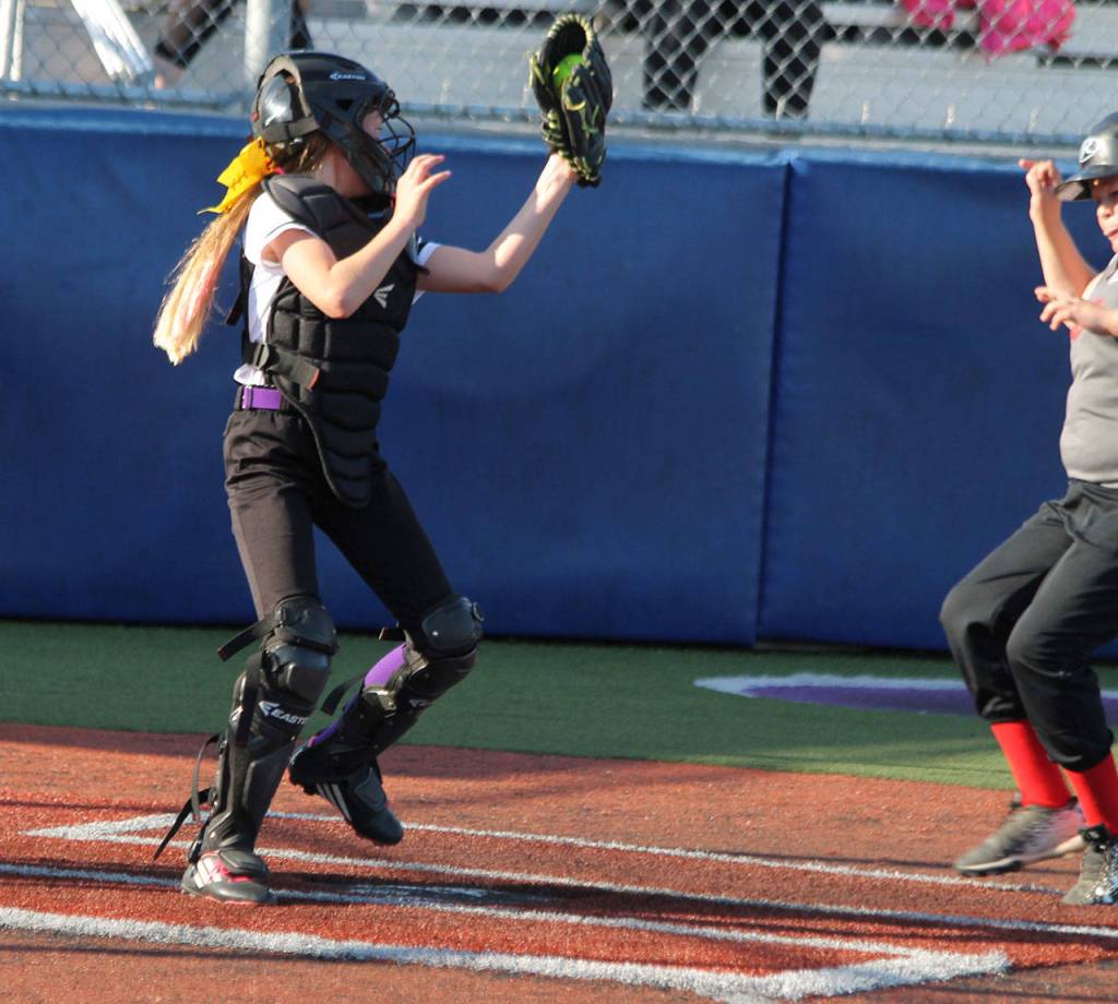 Caidence Meadors prepares to tag a Central Whidbey runner trying to score. (Photo by Jim Waller/Whidbey News-Times)