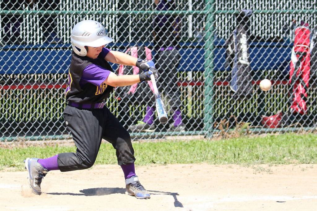 David Smith III rips a line drive in Saturday&rsquo;s district game. (Photo by John Fisken)