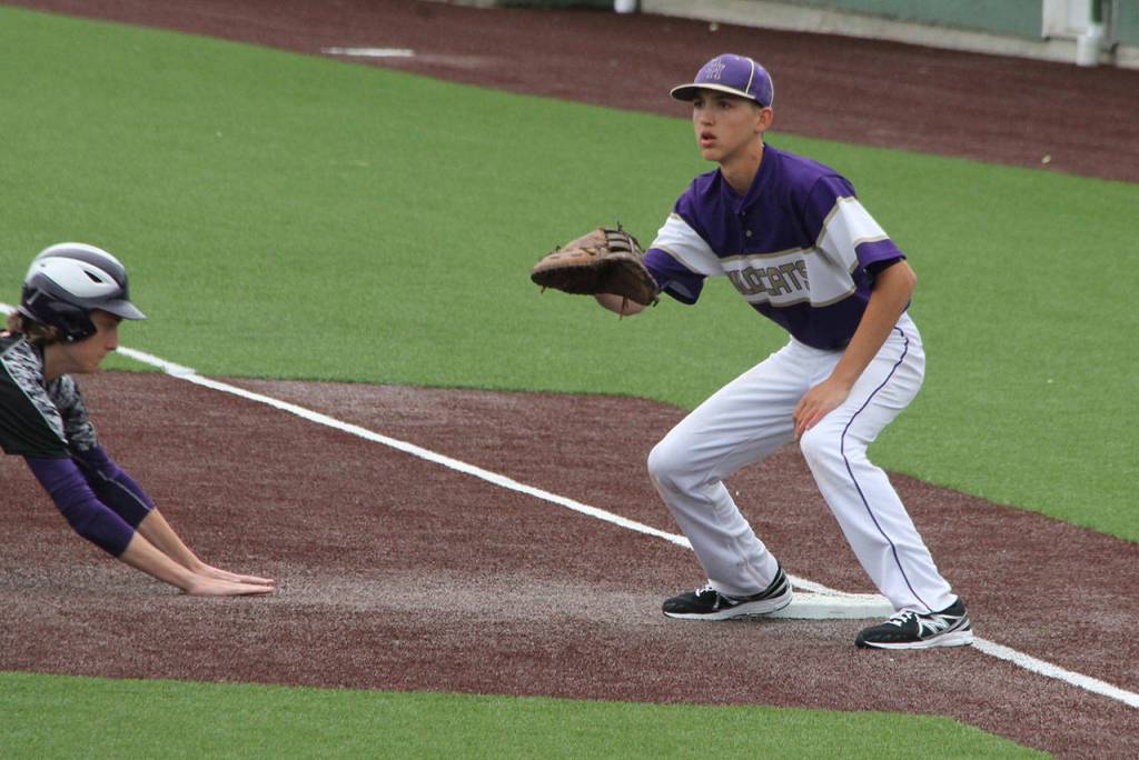 Oak Harbor Andrew Dixon waits for a pickoff throw Saturday. (Photo by Jim Waller/Whidbey News-Times)