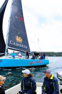 A chase boat takes in the start of competition at the Monday opening of Race Week. The annual event attracts sailors from the Northwest and Canada who compete daily in Penn Cove.