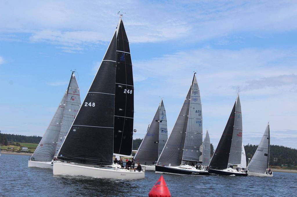 J-class boats line up for the start of race Monday. Many sails are not traditional white these days because they are made of lighter material, such as carbon fiber and Kevlar.